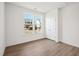 Bedroom featuring a window with neighborhood views, wood grain floors, and a closet at 121 Willow Cameron Way, Angier, NC 27501