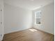 Bright bedroom with window, wood grain flooring, and closet at 121 Willow Cameron Way, Angier, NC 27501