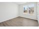 Bedroom featuring a window overlooking the neighborhood and wood grain floors at 121 Willow Cameron Way, Angier, NC 27501