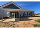 Stylish home exterior featuring a covered patio and ample natural light at 121 Willow Cameron Way, Angier, NC 27501