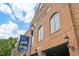 Exterior view of Varina Station with brick facade, arched windows, and inviting signage, creating a charming street presence at 121 Willow Cameron Way, Angier, NC 27501