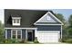 Newly constructed home features blue siding, a dark roof, and an attached two-car garage at 121 Willow Cameron Way, Angier, NC 27501