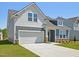 Attractive two-story home with a 2-car garage, stone accents, and well-maintained landscaping at 121 Willow Cameron Way, Angier, NC 27501
