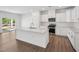 Open-concept kitchen featuring a large island and stainless steel appliances, seamlessly connected to the living space at 121 Willow Cameron Way, Angier, NC 27501
