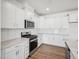 Modern kitchen features white cabinets, subway tile backsplash, and stainless steel appliances at 121 Willow Cameron Way, Angier, NC 27501