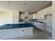 Unfinished kitchen featuring white cabinets, a central island, and modern design elements at 121 Willow Cameron Way, Angier, NC 27501