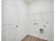 Utility room with washer/dryer hookups, shelving, and neutral wall paint at 121 Willow Cameron Way, Angier, NC 27501