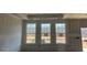 Unfinished living room featuring large windows, allowing natural light to stream into the space at 121 Willow Cameron Way, Angier, NC 27501
