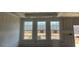 Unfinished living room with multiple windows, providing ample natural light at 121 Willow Cameron Way, Angier, NC 27501