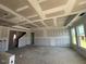 Spacious unfinished living area with tray ceiling and large windows allowing lots of natural light at 121 Willow Cameron Way, Angier, NC 27501