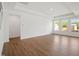 Spacious living area with tray ceiling, large windows, and wood-grain flooring at 121 Willow Cameron Way, Angier, NC 27501