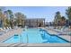 Community pool with lounge chairs, umbrellas and a covered picnic pavilion area at 121 Willow Cameron Way, Angier, NC 27501