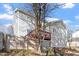 Rear view of home with sunroom and raised wooden deck visible behind a wooden privacy fence at 1218 Twelve Oaks Ln, Apex, NC 27502