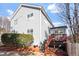 Back exterior featuring a two-story home and deck with painted stairs at 1218 Twelve Oaks Ln, Apex, NC 27502