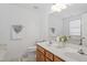 Bathroom featuring double sink vanity, large mirror and good lighting at 1218 Twelve Oaks Ln, Apex, NC 27502