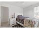 Bedroom showcases a single bed with a decorative floral blanket and bedside table at 1218 Twelve Oaks Ln, Apex, NC 27502