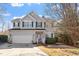 Charming two-story home with gray siding, green shutters, manicured lawn, and inviting front entrance at 1218 Twelve Oaks Ln, Apex, NC 27502