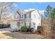 Traditional two-story home with neutral siding, green shutters, and landscaped yard at 1218 Twelve Oaks Ln, Apex, NC 27502