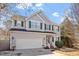 Two-story home with gray siding, green shutters, and attached two-car garage showcasing a well-maintained lawn at 1218 Twelve Oaks Ln, Apex, NC 27502