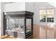 Modern fireplace with glass enclosure and a large window providing natural light in the background at 1218 Twelve Oaks Ln, Apex, NC 27502
