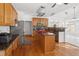 Well-equipped kitchen featuring granite countertops, stainless steel appliances, and a large island with bar stools at 1218 Twelve Oaks Ln, Apex, NC 27502