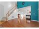 Spacious living room with hardwood floors, fireplace, and a staircase leading to the upper level at 1218 Twelve Oaks Ln, Apex, NC 27502