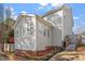 Rear exterior view of a home featuring a sunroom with bright windows at 1218 Twelve Oaks Ln, Apex, NC 27502