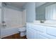 Bright bathroom featuring a shower-tub combo, white vanity, and modern fixtures at 13 Danbury Ct, Pittsboro, NC 27312