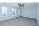 Spacious bedroom with plush carpeting, a ceiling fan, and plenty of natural light at 13 Danbury Ct, Pittsboro, NC 27312