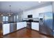 Modern kitchen with white cabinets, stainless steel appliances, and an open layout at 13 Danbury Ct, Pittsboro, NC 27312