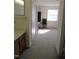 View from the bathroom showing a carpeted bedroom with a desk, chair, and window at 139 Kingsbury Dr, Chapel Hill, NC 27514