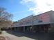 Exterior view of a commercial building with a row of various stores with cars parked nearby at 139 Kingsbury Dr, Chapel Hill, NC 27514