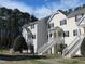 Inviting multi-Gathering exterior with white stairs and trim against a bright blue sky at 139 Kingsbury Dr, Chapel Hill, NC 27514