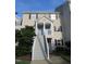 Inviting townhouse featuring a covered entrance with a stairway and a well-maintained lawn at 139 Kingsbury Dr, Chapel Hill, NC 27514