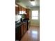 Functional kitchen with wood cabinets, a stainless steel stove, and a double basin sink at 139 Kingsbury Dr, Chapel Hill, NC 27514