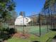 Well-maintained tennis court featuring black fencing and lush green surroundings at 139 Kingsbury Dr, Chapel Hill, NC 27514