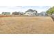 Expansive backyard features a wooden fence and a charming two-story home with ample space for outdoor activities and entertaining at 1426 Phelps Ridge Dr, Fuquay Varina, NC 27526