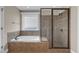 Bathroom with a soaking tub and separate glass shower stall at 1426 Phelps Ridge Dr, Fuquay Varina, NC 27526