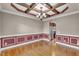 Bright dining room with hardwood floors, chandelier, and decorative trim, opening to kitchen at 1426 Phelps Ridge Dr, Fuquay Varina, NC 27526