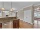 Open-concept kitchen with granite countertops and stainless steel appliances, flowing into the living area at 1426 Phelps Ridge Dr, Fuquay Varina, NC 27526