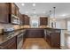 Spacious kitchen with granite countertops, stainless steel appliances, and dark wood cabinets at 1426 Phelps Ridge Dr, Fuquay Varina, NC 27526