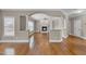Spacious living room with hardwood floors, fireplace, and decorative columns at 1426 Phelps Ridge Dr, Fuquay Varina, NC 27526