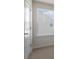 A carpeted bedroom with large window for natural light and a door at 144 Paper Birch Way, Fuquay Varina, NC 27526