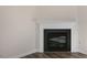 Close up of modern fireplace with a white mantle and attractive wood-look floors at 144 Paper Birch Way, Fuquay Varina, NC 27526