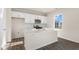 Bright kitchen features white cabinets, stainless steel appliances, a central island, and hardwood floors at 144 Paper Birch Way, Fuquay Varina, NC 27526