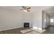 Open-concept living room with a fireplace, ceiling fan, and beautiful floors at 144 Paper Birch Way, Fuquay Varina, NC 27526