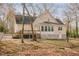 Back exterior view of home, showing deck and sunroom with many windows at 1514 Wiljohn Rd, Garner, NC 27529