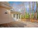 Exterior backyard view highlighting wooden deck and large windows overlooking nature at 1514 Wiljohn Rd, Garner, NC 27529
