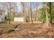 Home's backyard with small stream running through the wooded lot at 1514 Wiljohn Rd, Garner, NC 27529