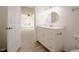 Bright bathroom featuring a white vanity and a decorative, round mirror at 1514 Wiljohn Rd, Garner, NC 27529